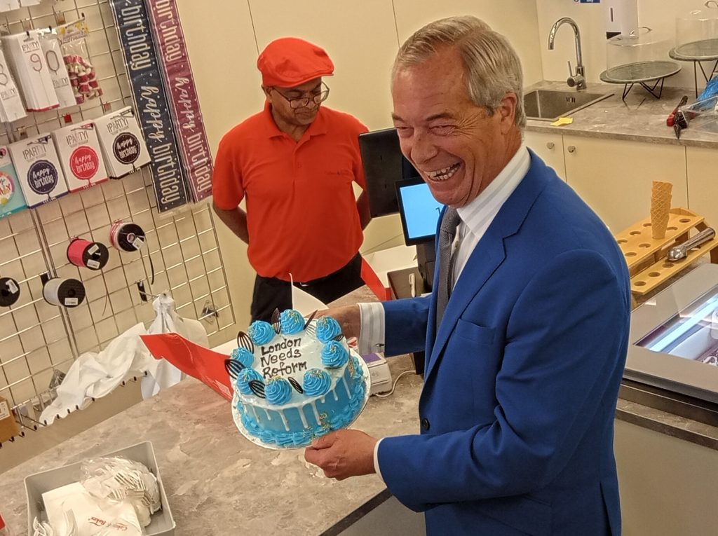 Nigel Farage is presented with a cake saying 'London needs Reform' (credit LDRS/Nick Clark)