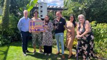 Council leader Dominic Twomey (left) and cabinet member for housing Maureen Worby (right) with winners Abul and Nour, sponsor David from Chandlers Roofing Supplies, and housing officer Emma