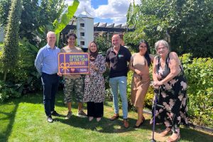 Council leader Dominic Twomey (left) and cabinet member for housing Maureen Worby (right) with winners Abul and Nour, sponsor David from Chandlers Roofing Supplies, and housing officer Emma